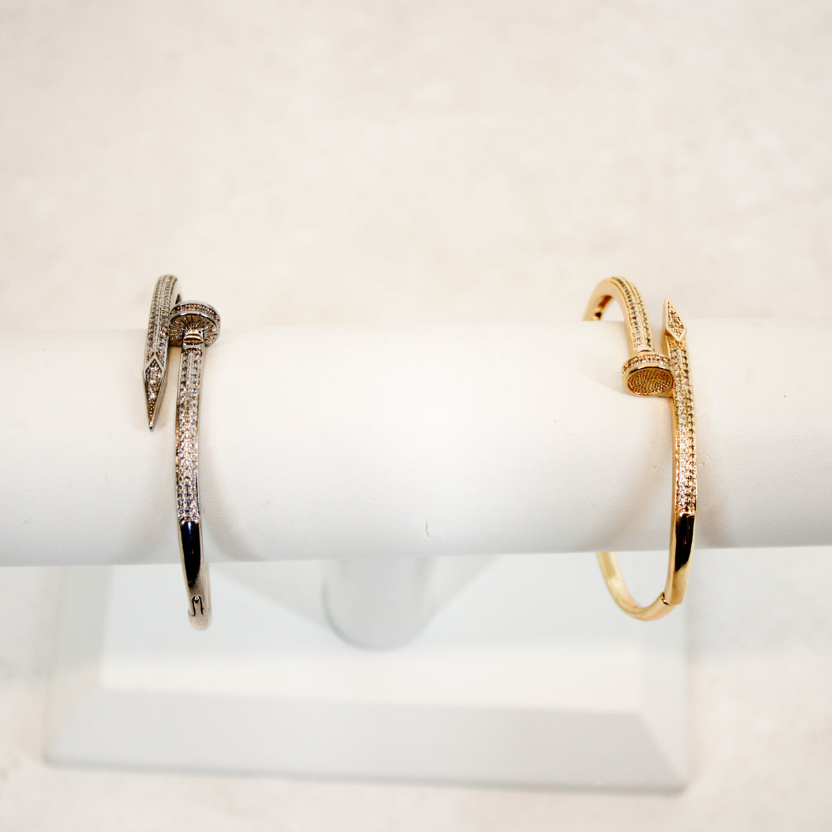 Nail Bangle Bracelet gold and silver on display