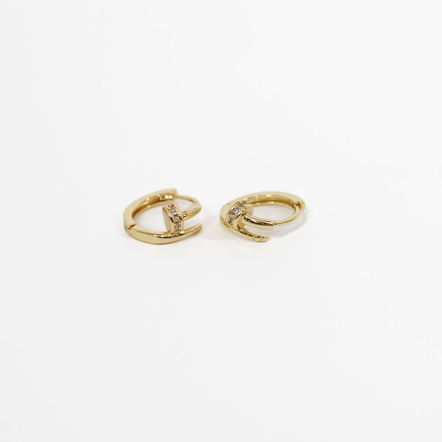 Nail huggie earrings on a white background 