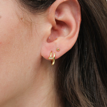 Nail huggie earring gold on ear 