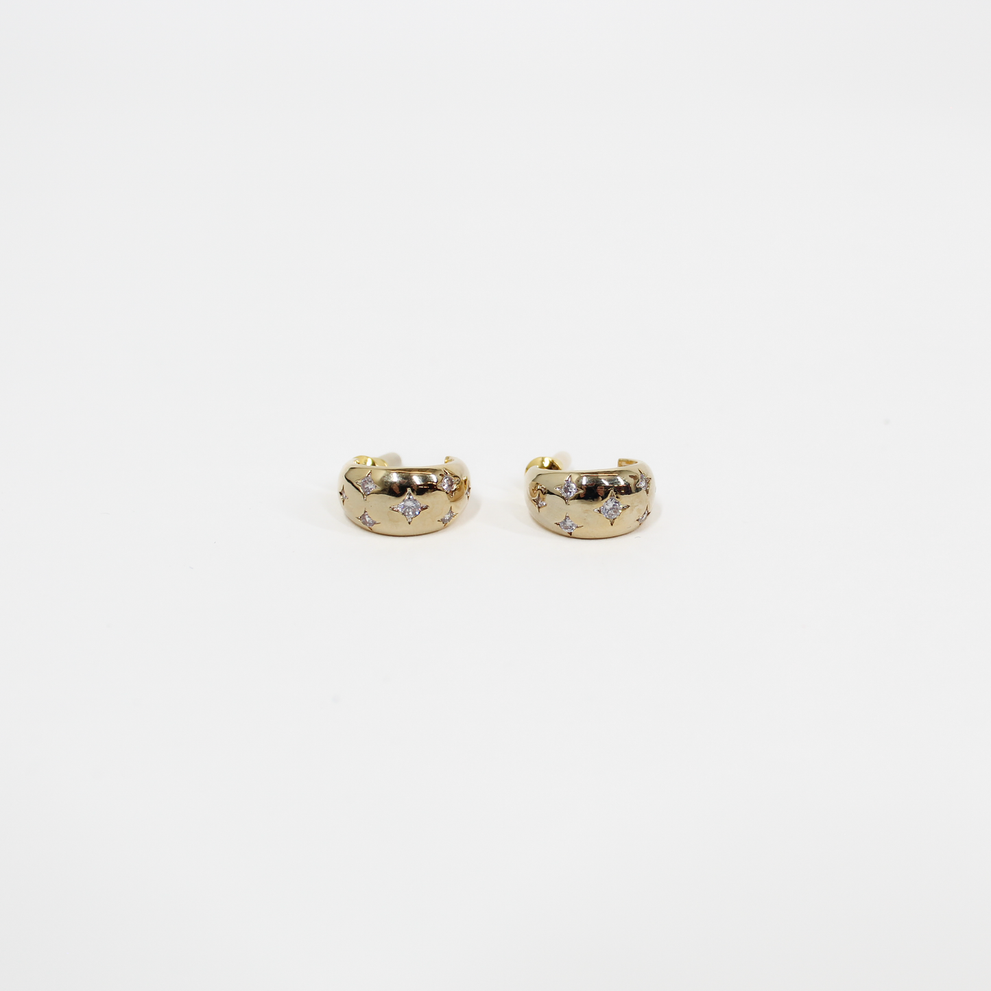 Gold northern stars hoop earrings with embedded stones on a white background