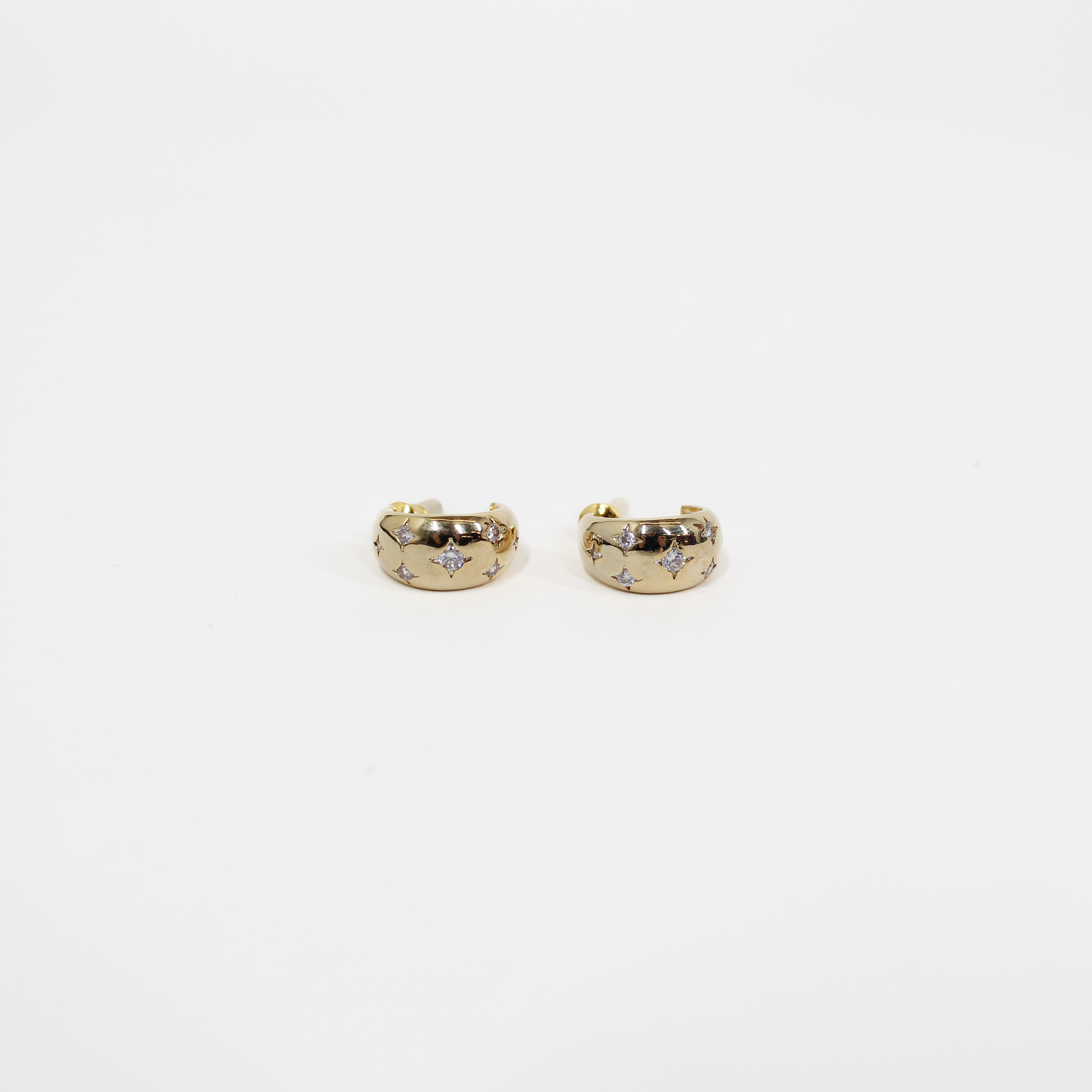 Gold northern stars hoop earrings with embedded stones on a white background