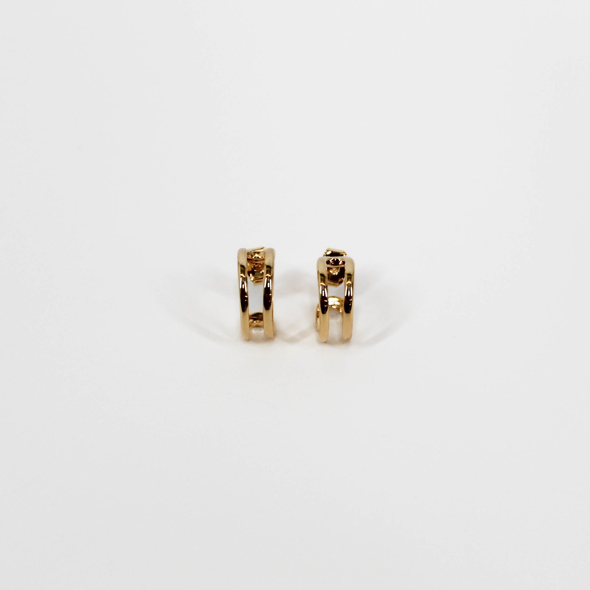 Gold open mini hoop earrings on a white background