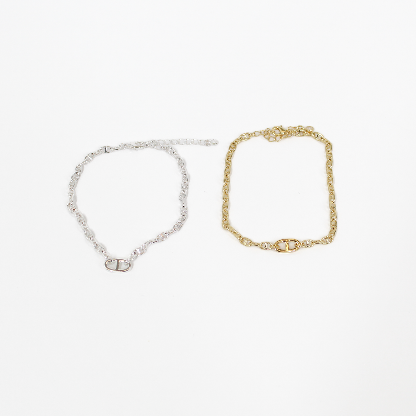 Gold and silver oval link chan bracelets on a white background