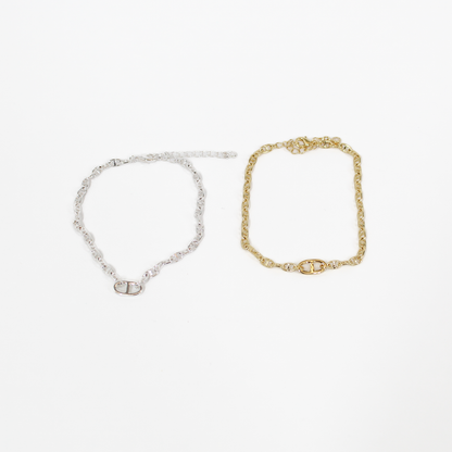 Gold and silver oval link chan bracelets on a white background