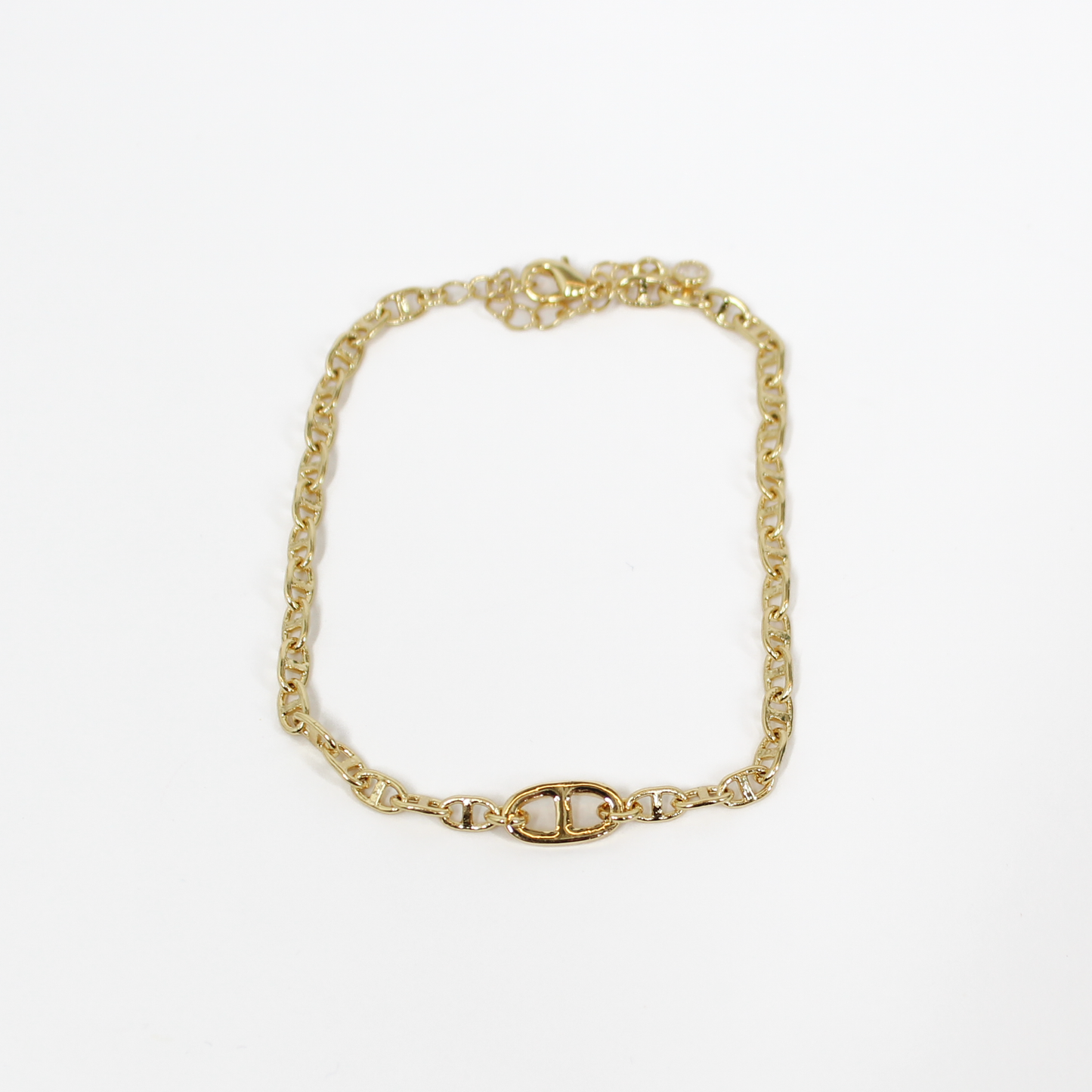 Gold oval link chain bracelet on a white background