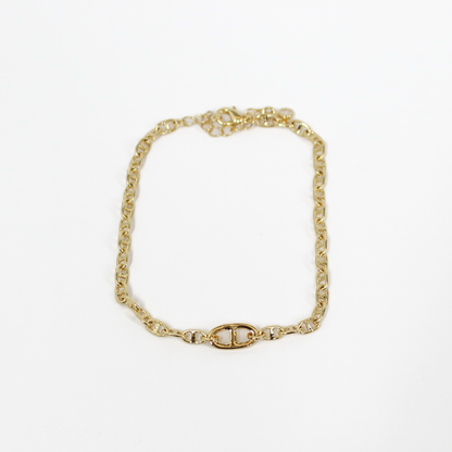 Gold oval link chain bracelet on a white background