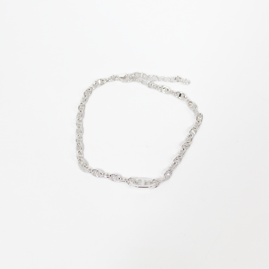 Silver oval link chain bracelet on a white background