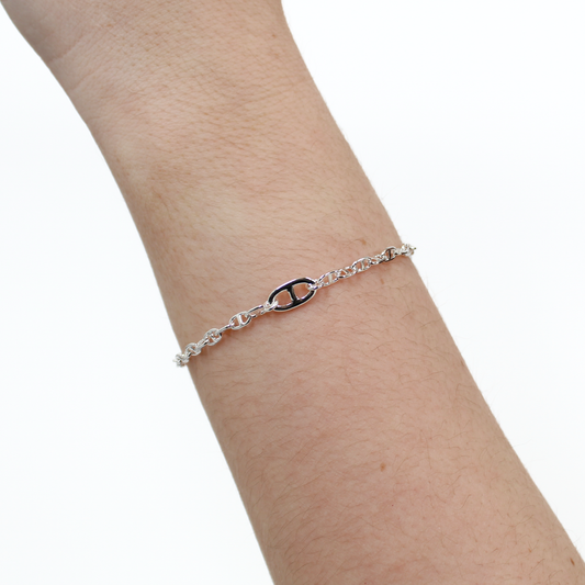 Silver Oval Link bracelet on a person's wrist against a white background