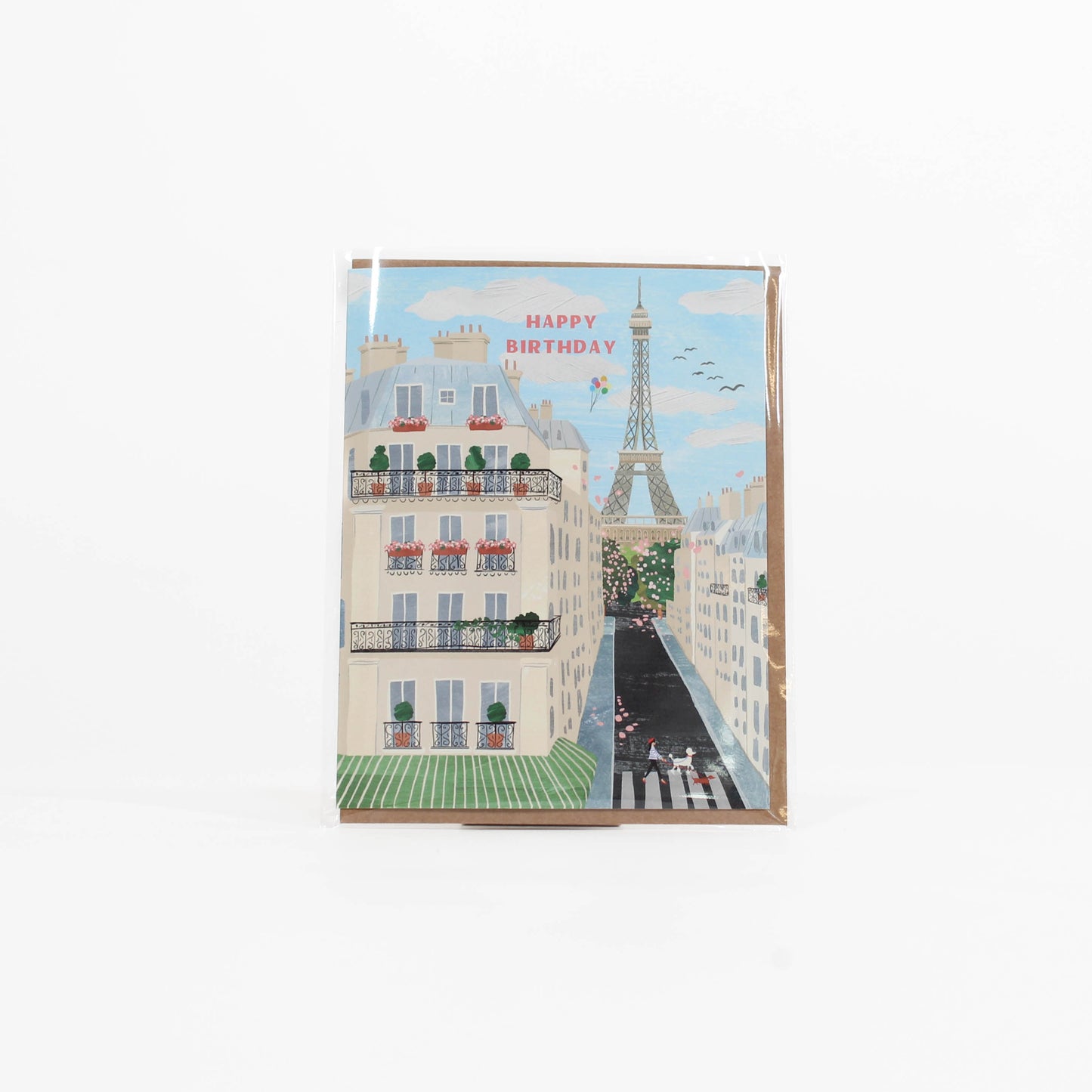 Greeting card with a Parisian street scene and Eiffel Tower, featuring 'Happy Birthday' text.