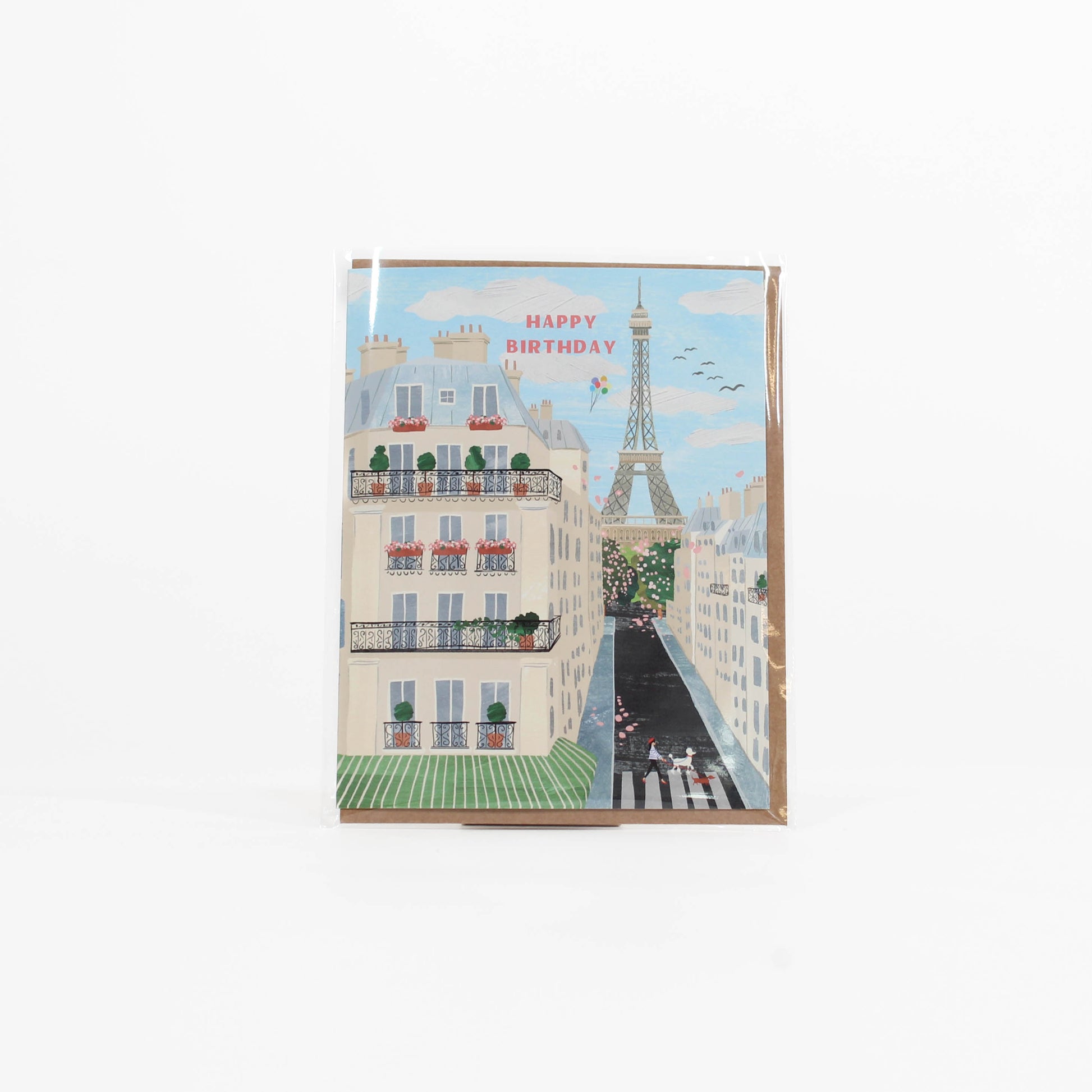 Greeting card with a Parisian street scene and Eiffel Tower, featuring 'Happy Birthday' text.