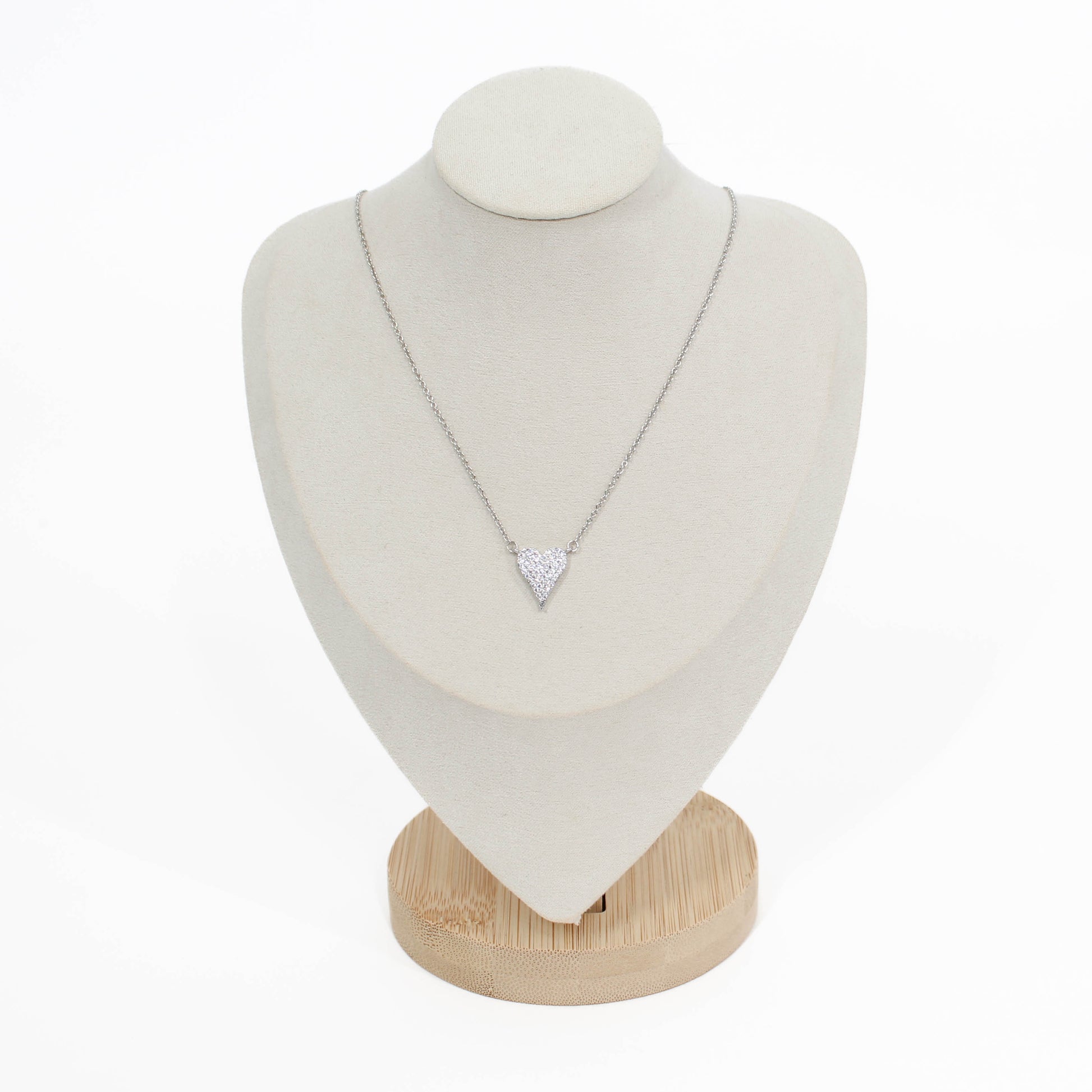 Silver pave heart crystal necklace on a white mannequin bust