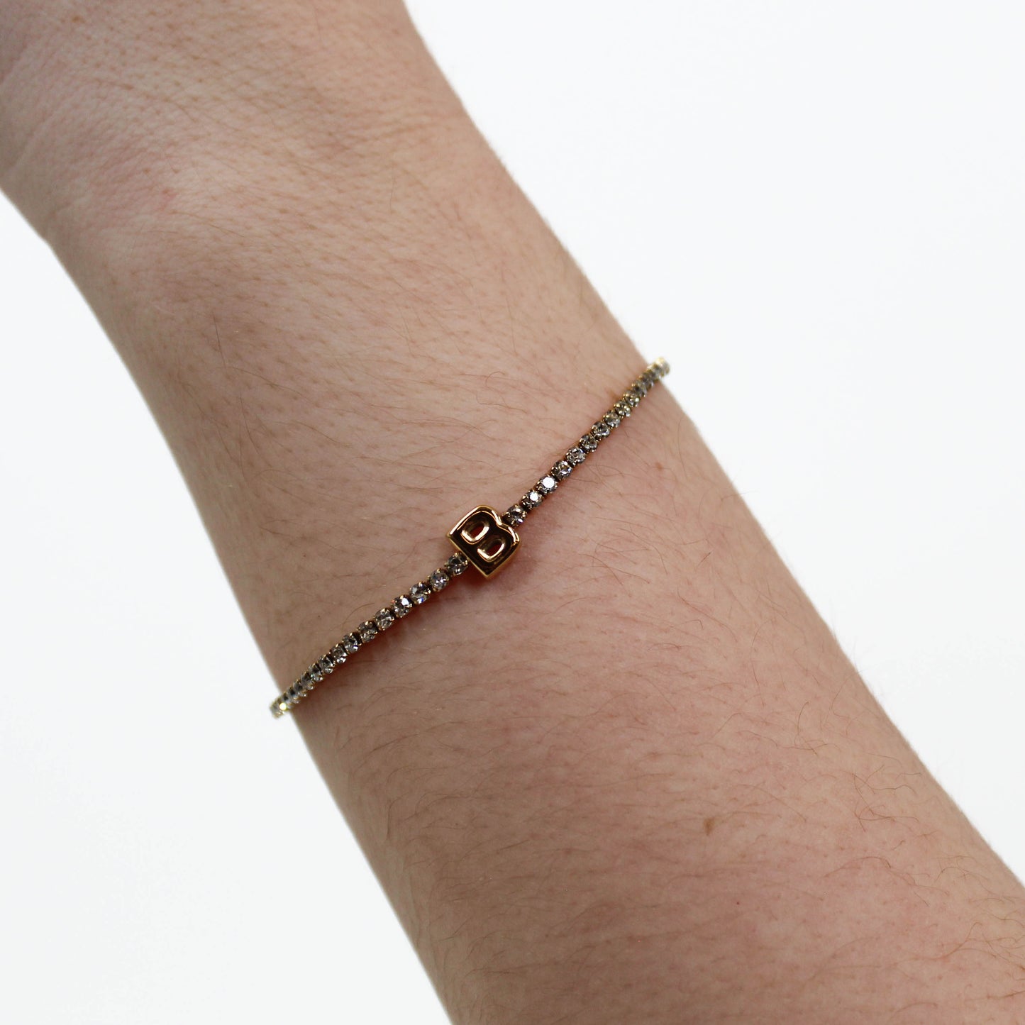 Rhinestone Letter Bracelet B on a wrist with a white background