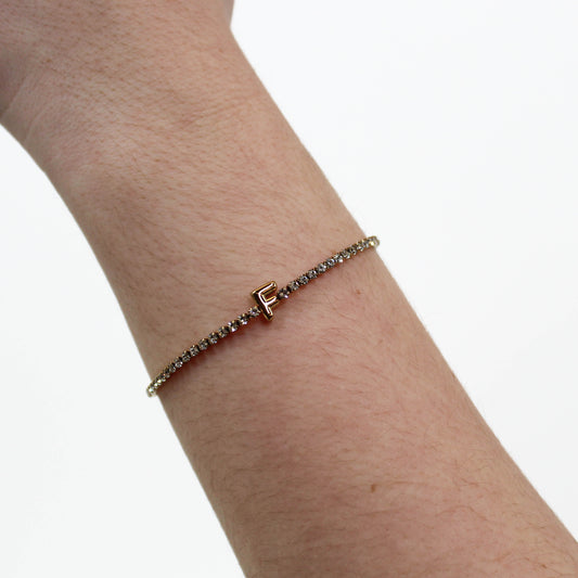 Rhinestone Letter Bracelet F on a wrist with a white background