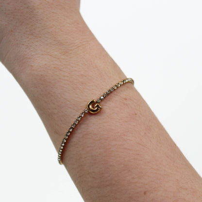 Rhinestone Letter Bracelet G on a wrist with a white background
