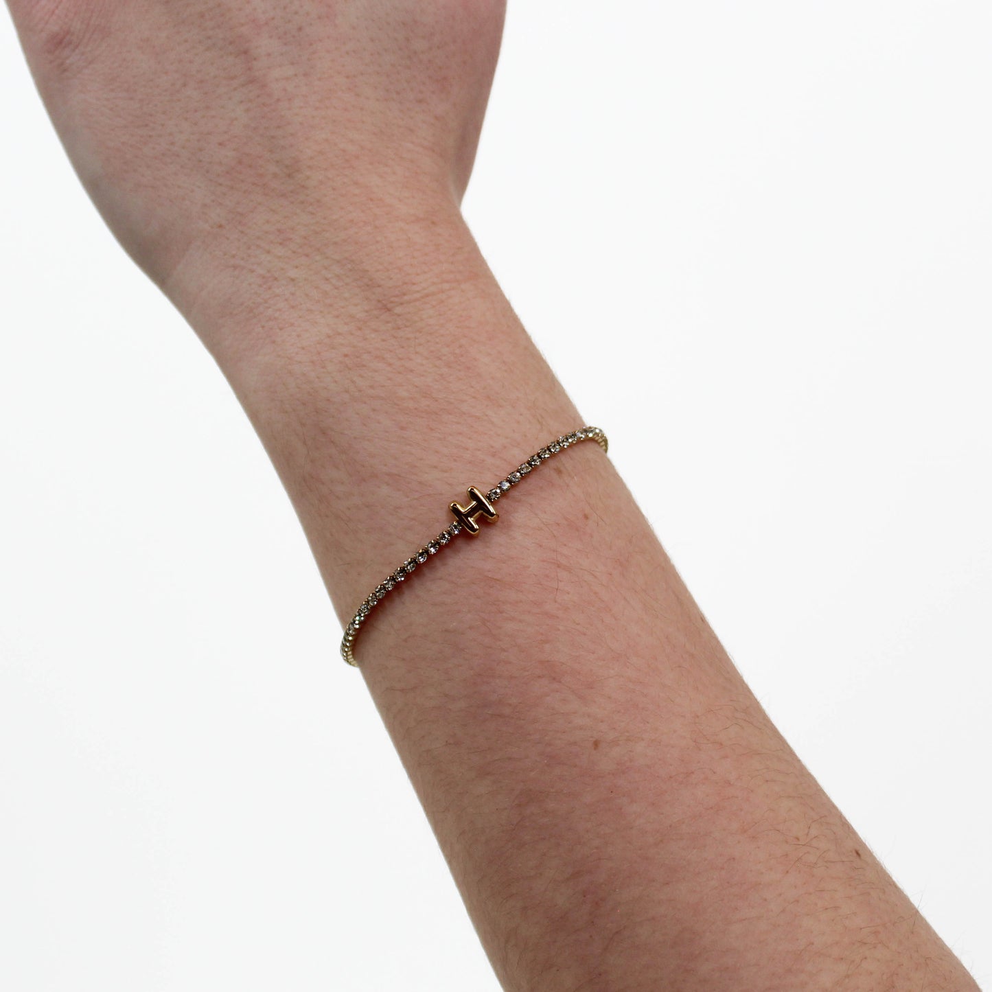Rhinestone Letter Bracelet H on a wrist with a white background