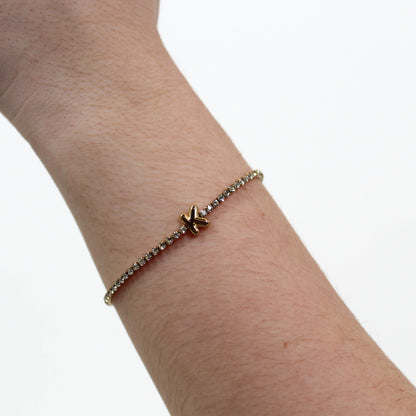 Rhinestone Letter Bracelet K on a wrist with a white background