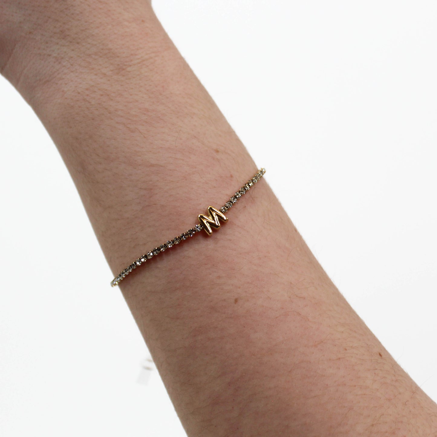 Rhinestone Letter Bracelet M on a wrist with a white background 
