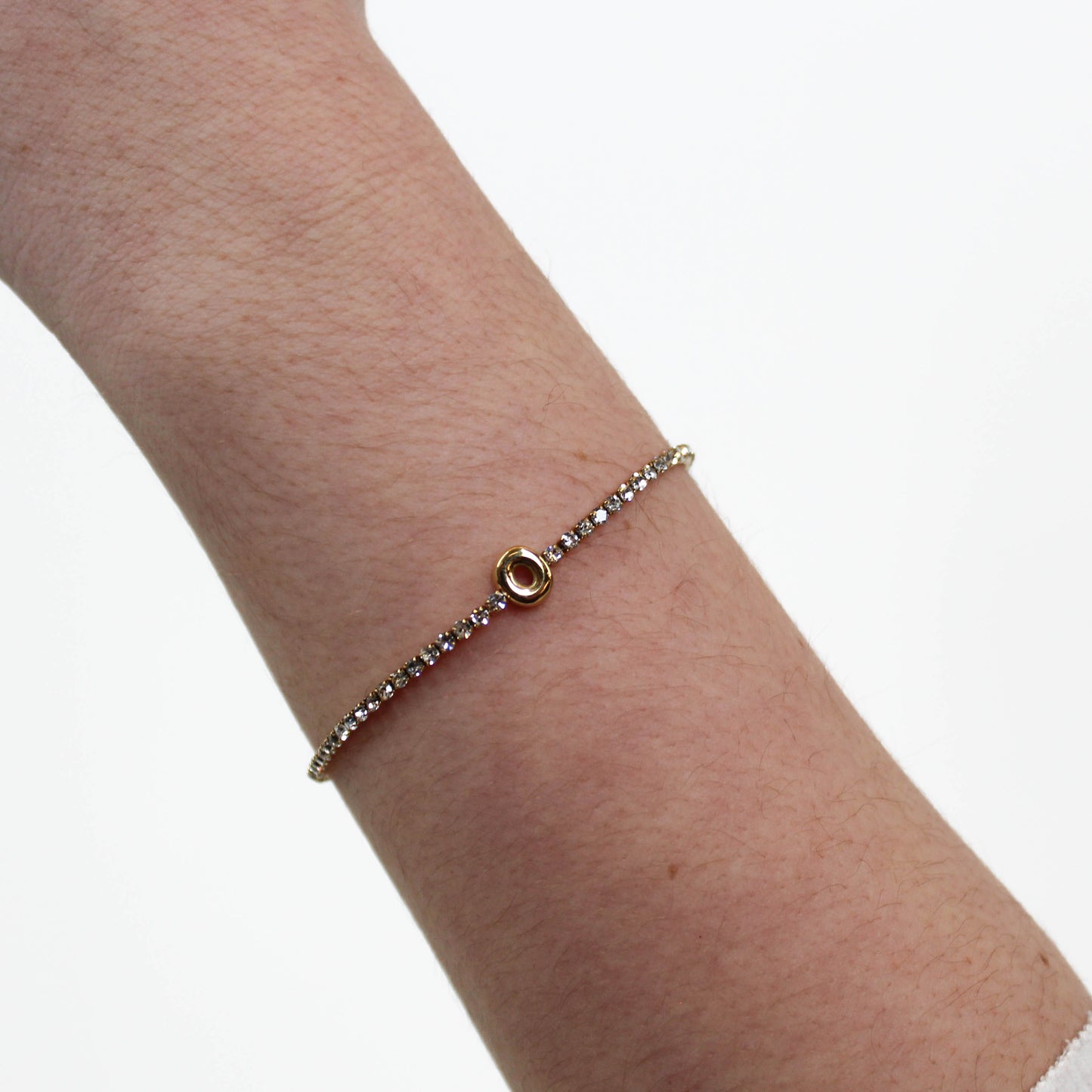 Rhinestone Letter Bracelet on a wrist with a white background