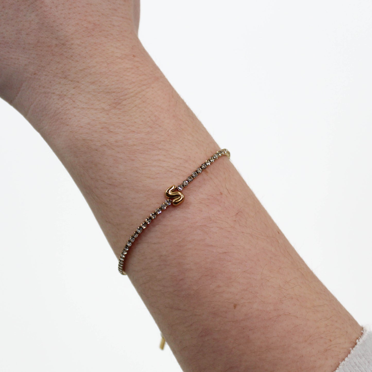 Rhinestone Letter Bracelet S on a wrist with a white background