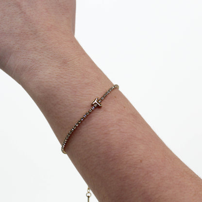 Rhinestone Letter Bracelet T on a wrist with a white background