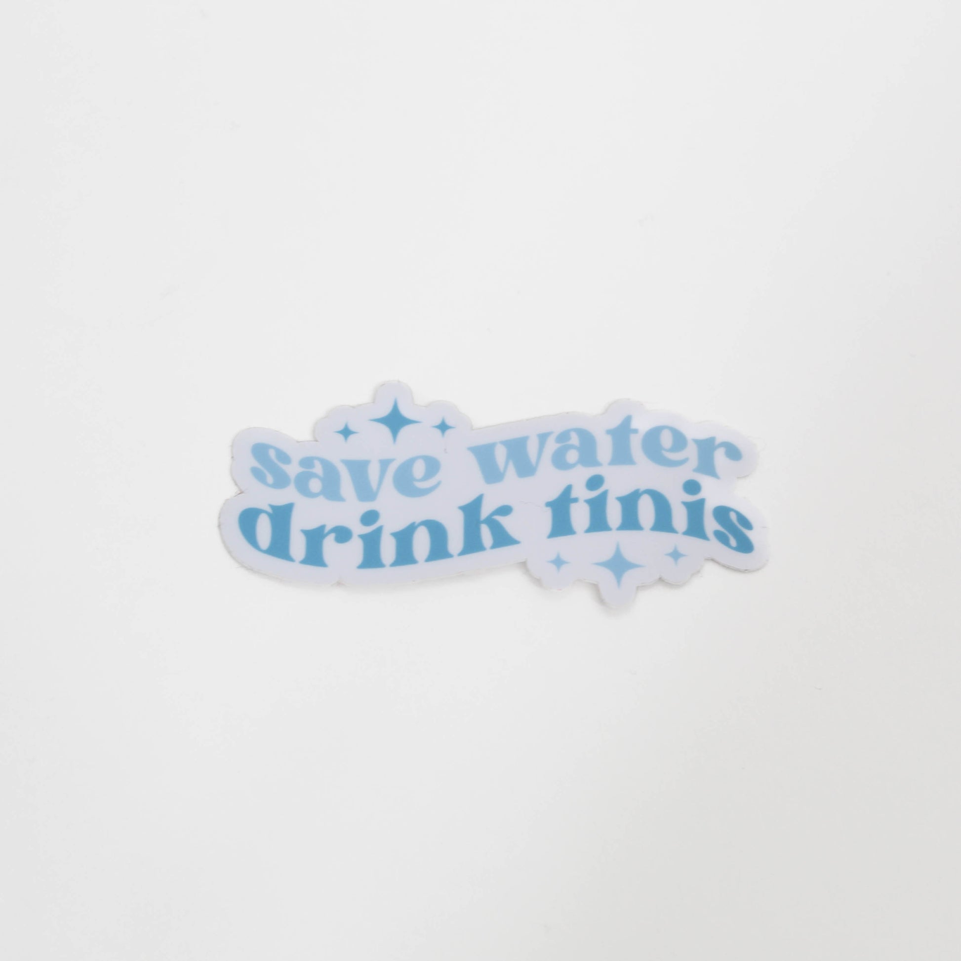 Sticker with 'save water drink tinis' text on a white background