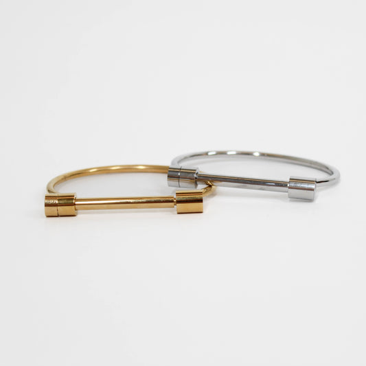 Gold and silver screw cuff bracelet bangle on a white background