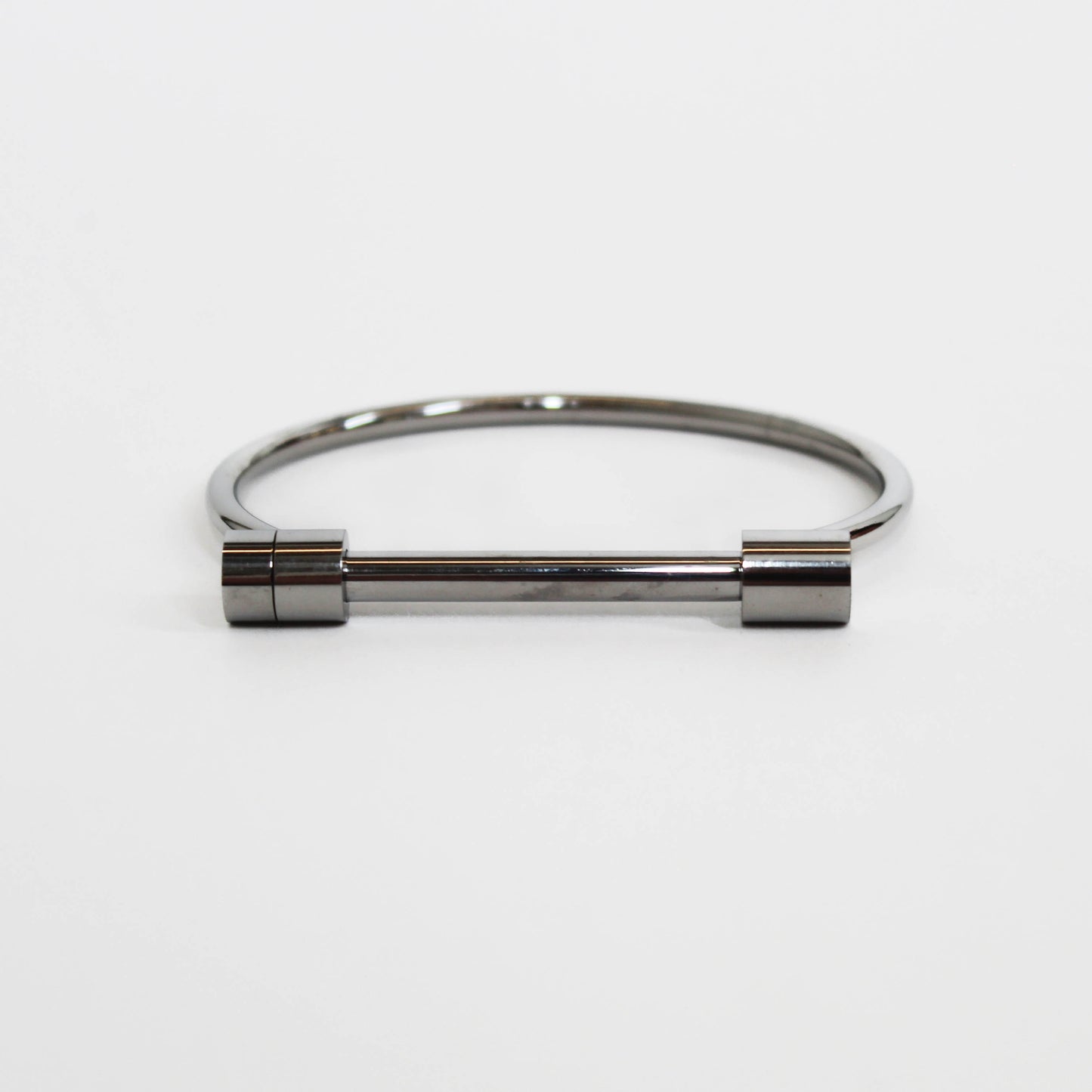 Silver cylindrical screw cuff bracelet on a white background