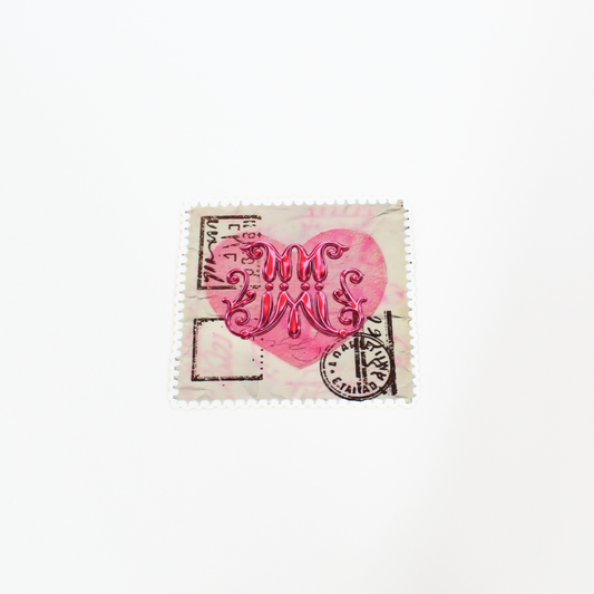 Decorative stamp with a pink heart and black text on a white background
