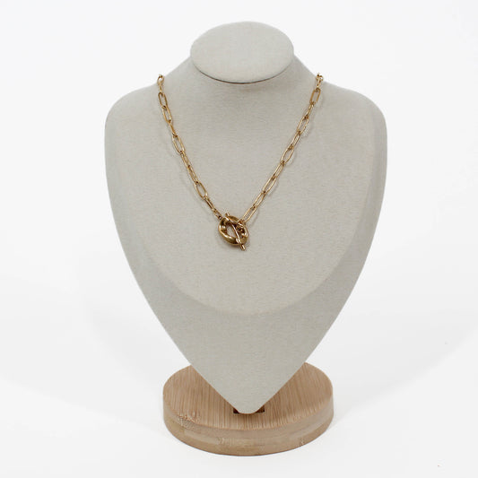 Gold chain sculpted toggle necklace on a white mannequin bust.