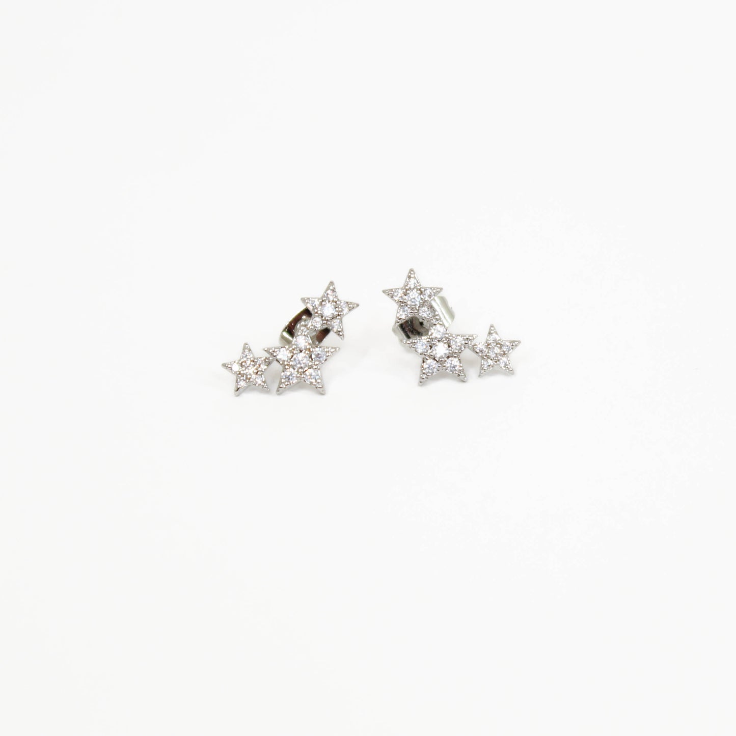 Shooting star-shaped earrings with clear stones on a white background