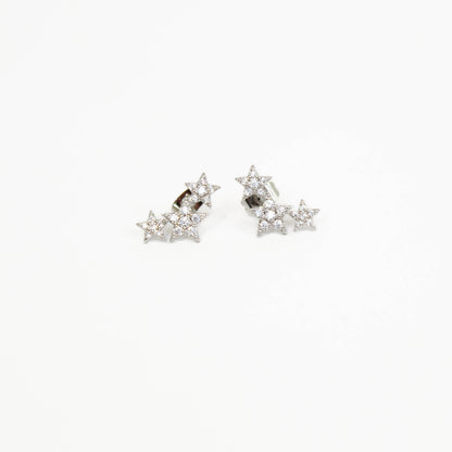 Shooting star-shaped earrings with clear stones on a white background