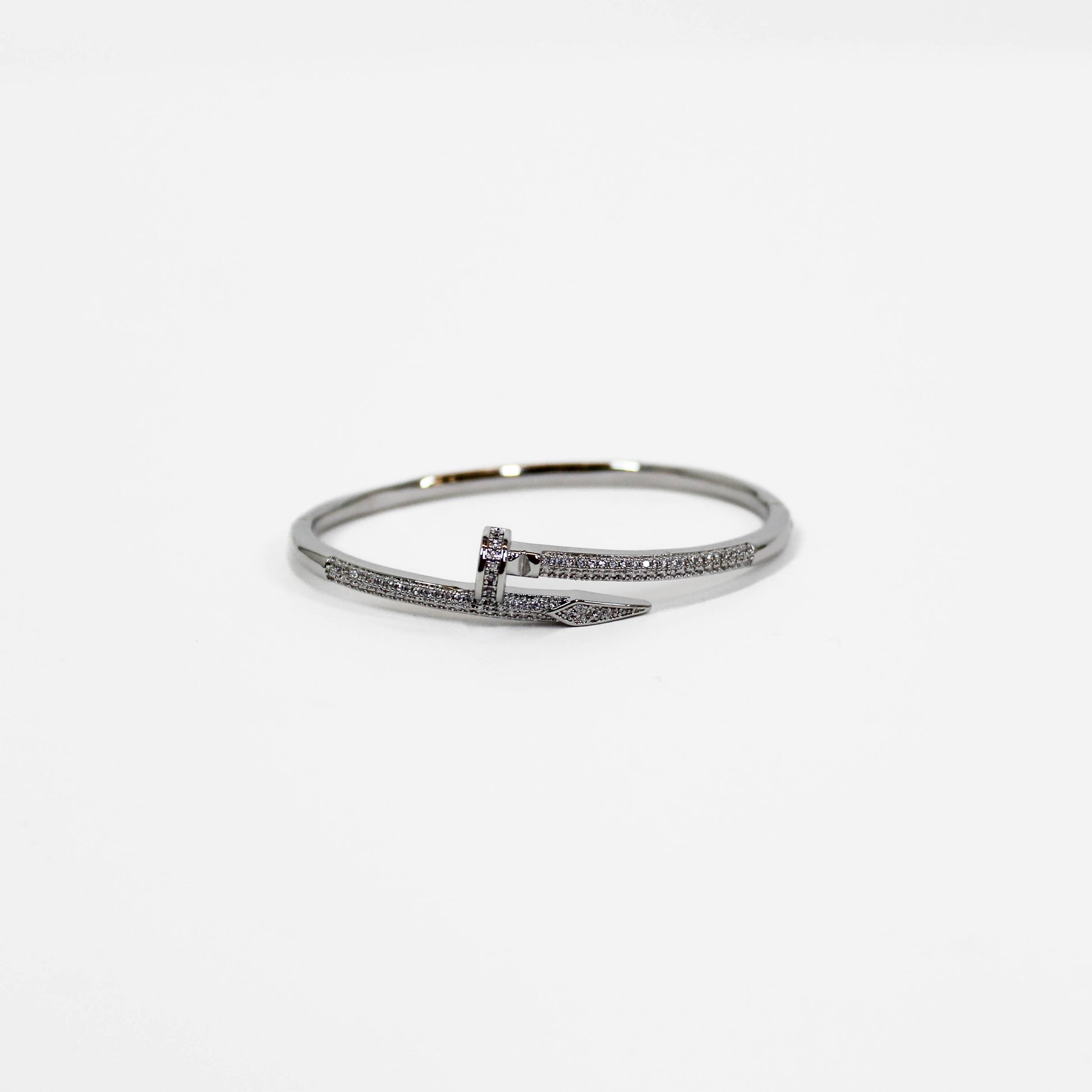 Silver nail bangle bracelet on a white background