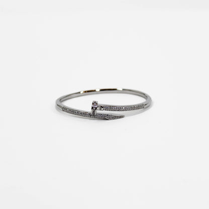 Silver nail bangle bracelet on a white background