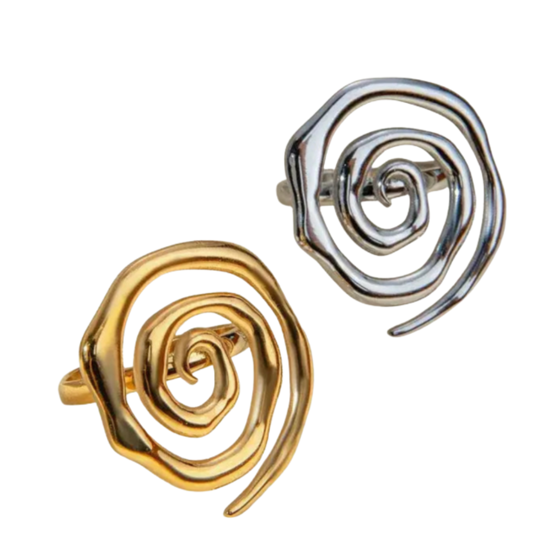 Gold and silver spiral rings on a white background