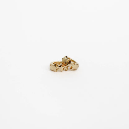 Gold Star huggie earrings on a white background. 