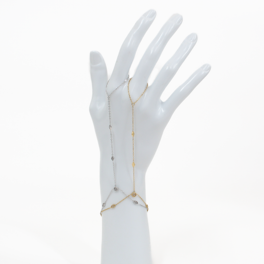 Gold and silver stone charm hand chain bracelet on a white mannequin hand against a white background