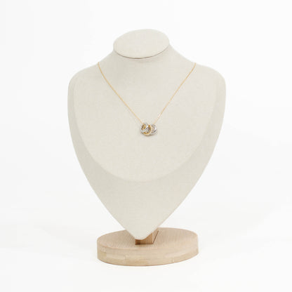 gold Three Ring pendant necklace on a mannequin bust with a white background