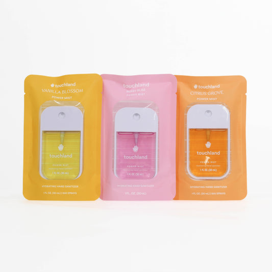 Touchland hand sanitizers in vanilla blossom, berry bliss, and citrus groove