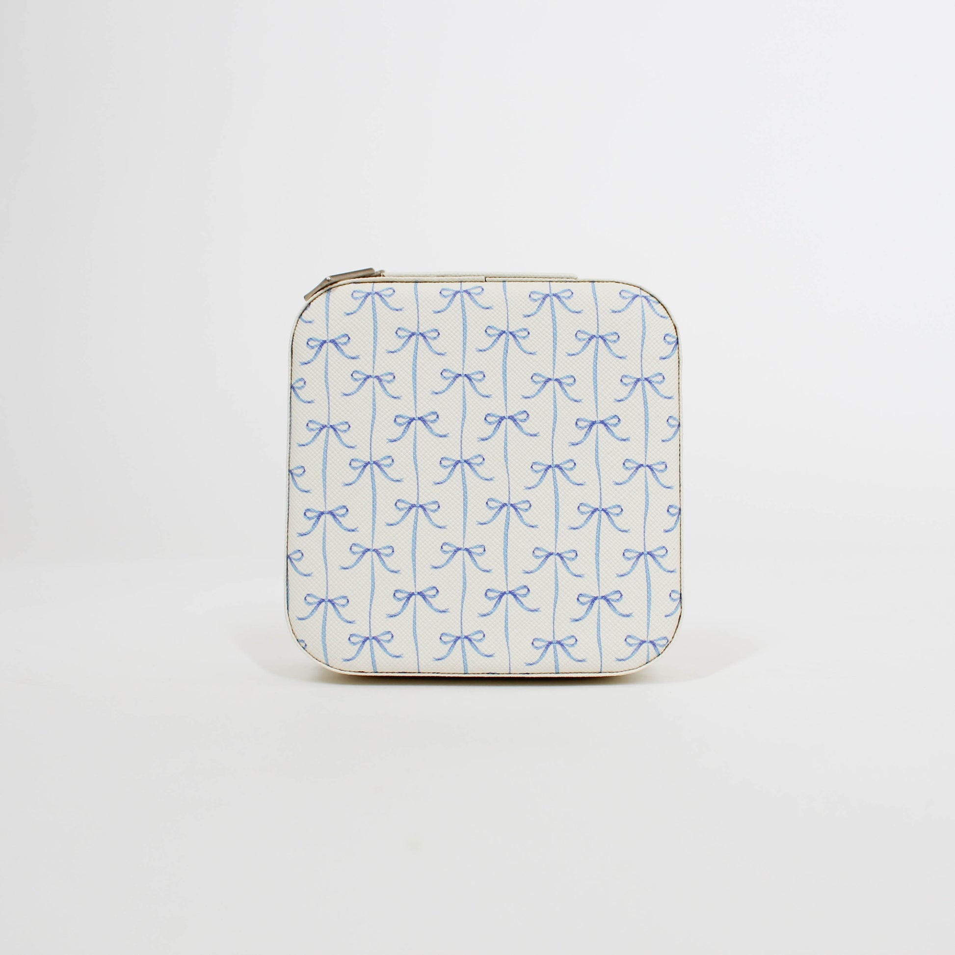 travel jewelry organizer with blue bow pattern on a white background