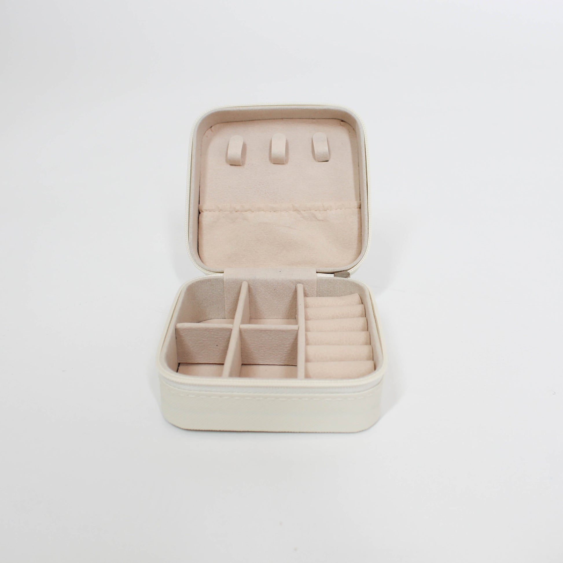 inside of travel jewelry organizer with compartments on a white background