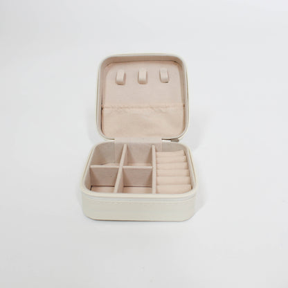 inside of travel jewelry organizer with compartments on a white background
