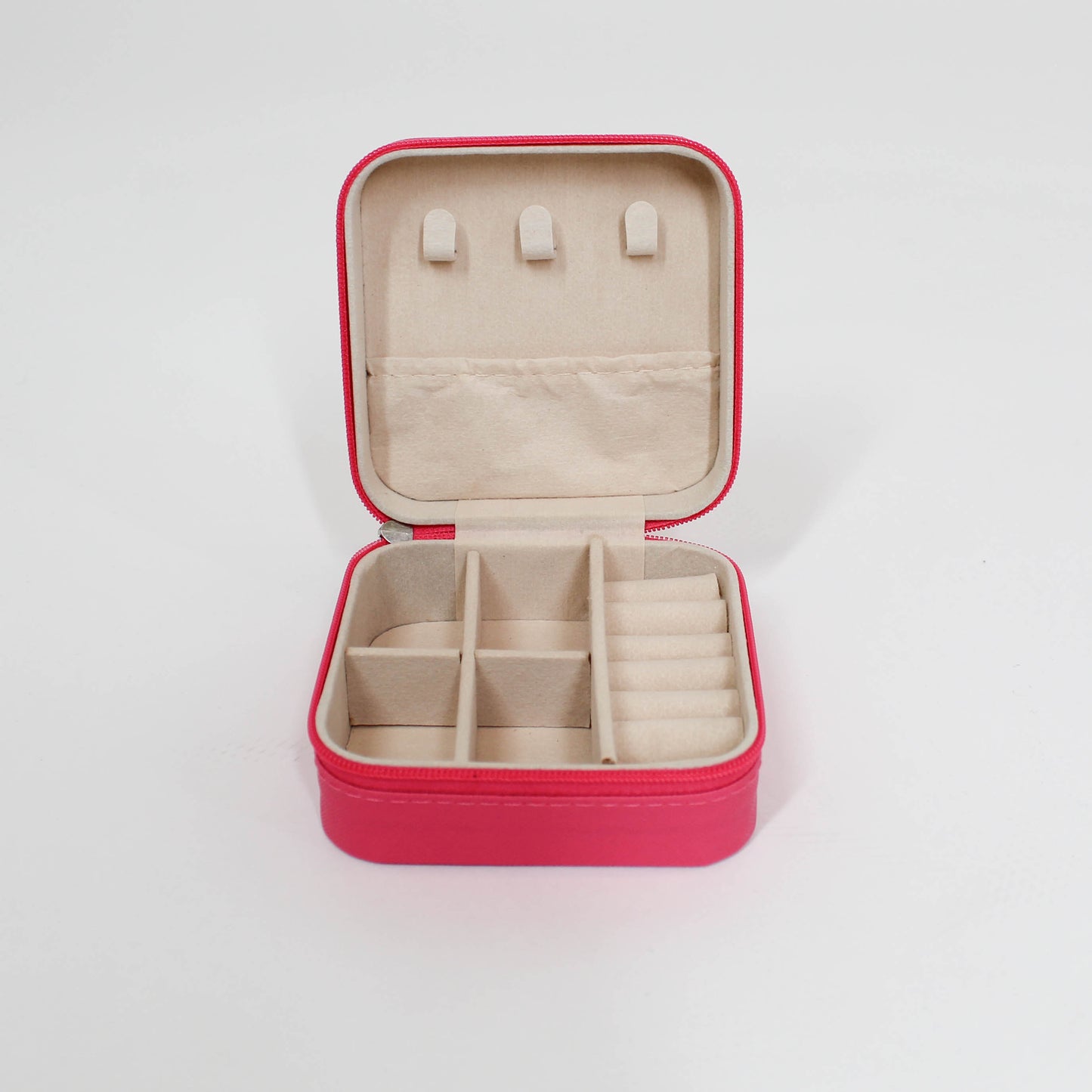 Pink jewelry case with beige interior on a white background