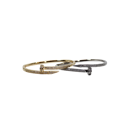 Two nails bangle bracelets in silver and gold on white background