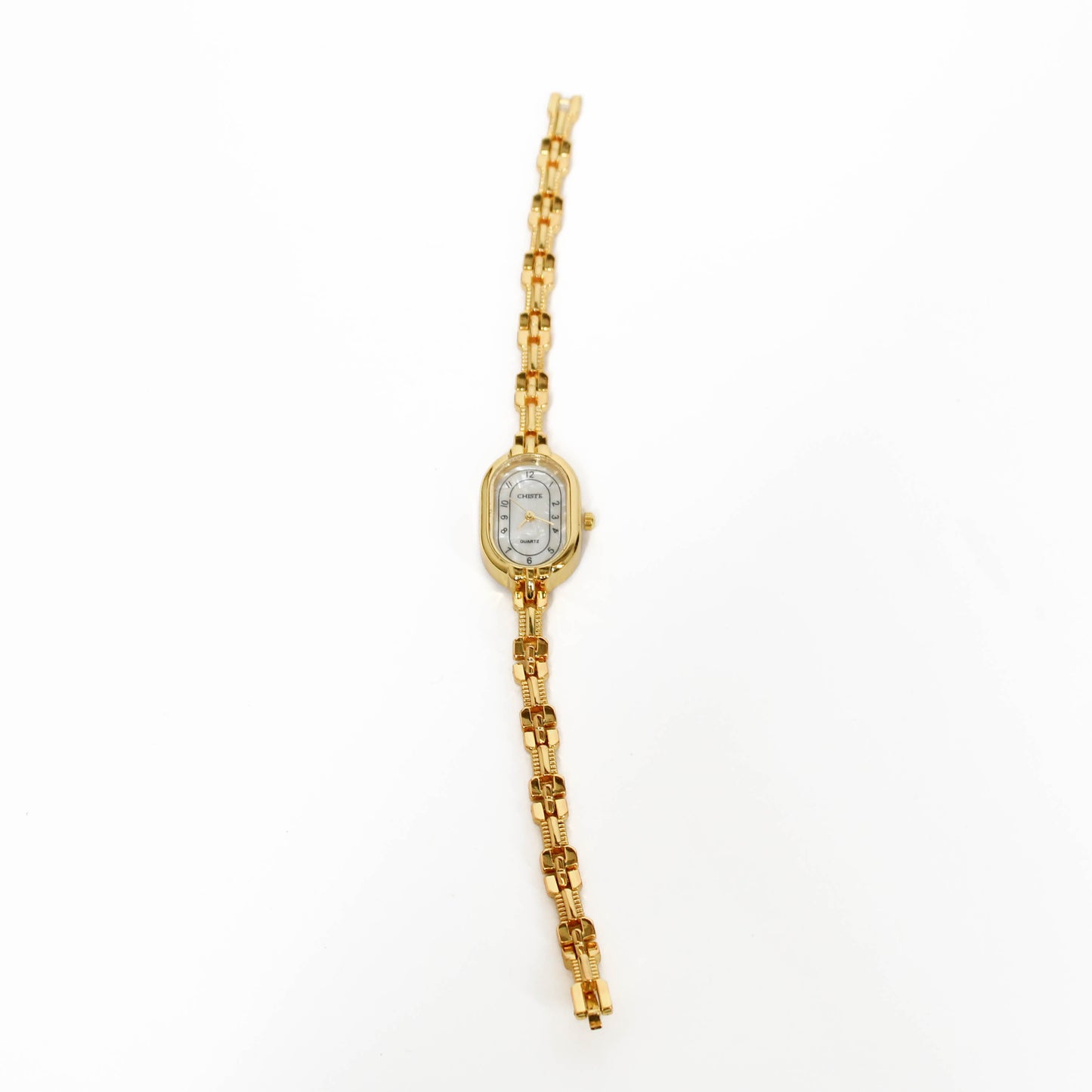 Gold vintage oval watch with a white face on a white background 