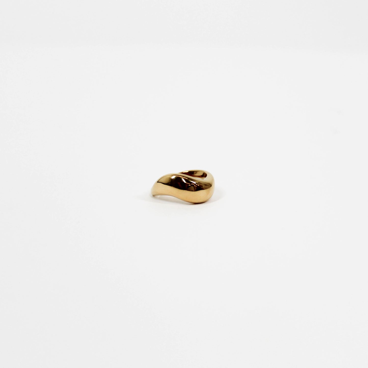 Gold wavy ring on a white background