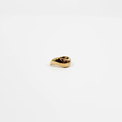 Gold wavy ring on a white background