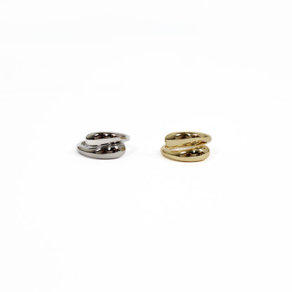 Two spiral-shaped wrap rings, one silver and one gold, on a white background.