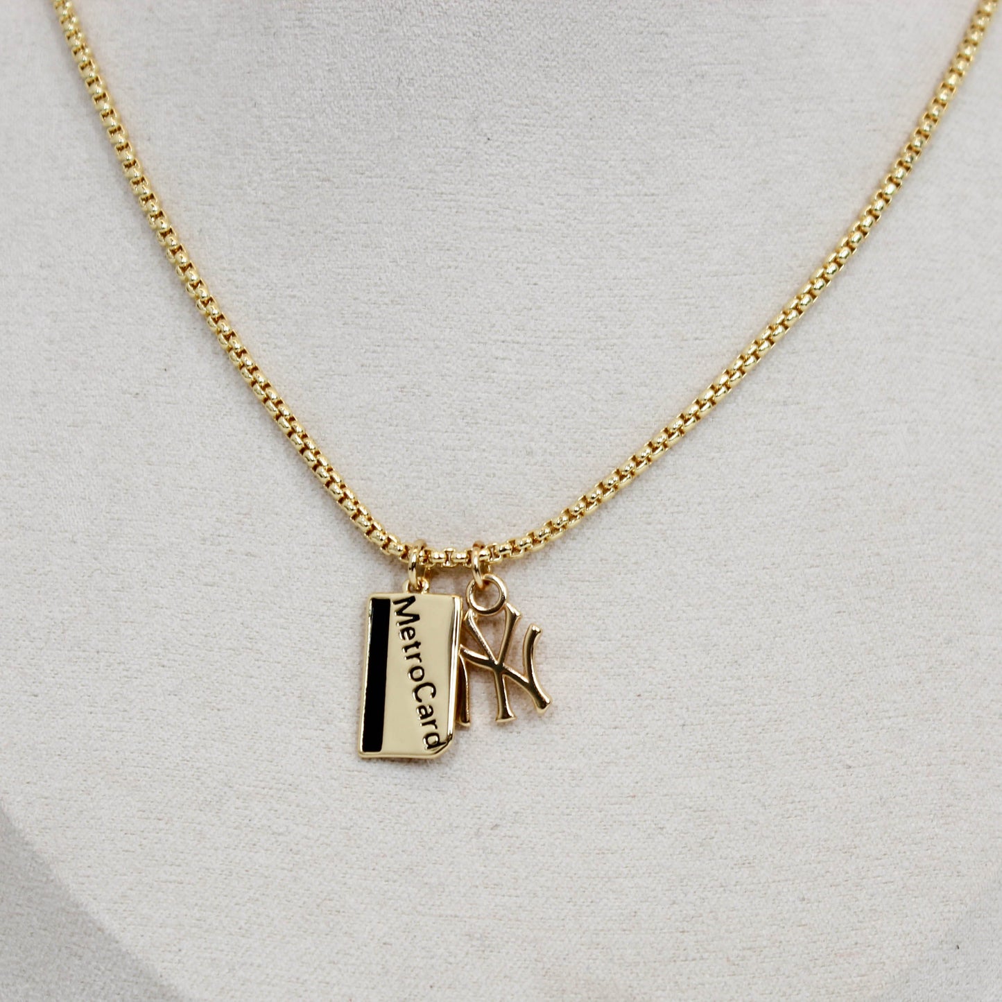 Gold yankee charm pendant necklace with metro card charms