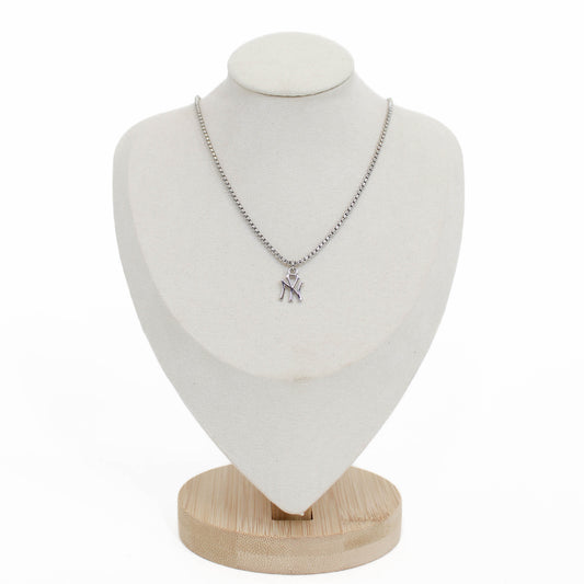 Necklace with a New York yankees pendant on a white mannequin bust with a wooden base