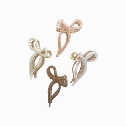 gold metal and brown plastic bow claw clip, gold metal and white plastic bow claw clip, gold metal and pink plastic bow claw clip, and gold metal and pearl plastic bow claw clip